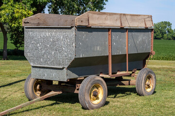 Fototapeta premium Close up abstract view of a vintage tractor or truck drawn grain wagon trailer farm implement, used for hauling harvested grain