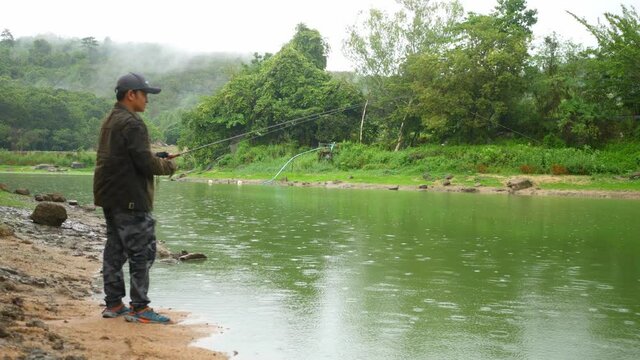 A man fishing in a large lagoon, weekend leisure activity.