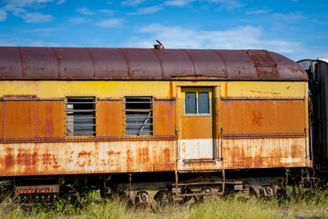 Photo of a rusted old passenger train abandoned weeathering