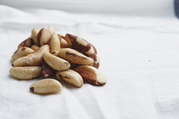 The fruit of the Brazilian nut on a white background. A bunch of vegan nuts. Useful food with radium