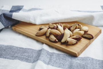 The fruit of the Brazilian nut on a white background. A bunch of vegan nuts. Useful food with radium