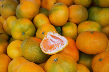 Background of ripe tangerines. Tangerines are sold at the market. Tangerines are new year's fruits, delicious and healthy citrus fruits.