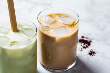 Cold summer drinks concept. Ice latte matcha and ice latte coffee in glasses, white background.