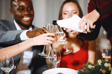 Pours champagne into glasses at the festival