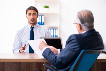 Young male candidate employee meeting with old recruiter