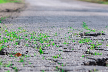 Bad, broken road, spoiled asphalt, holes and pits on the way