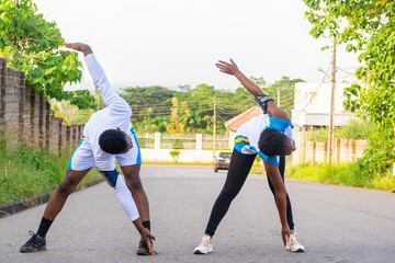 young man and woman stretching together outdoor