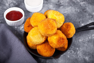 Potato croquettes balls on the iron pan and dips sauces