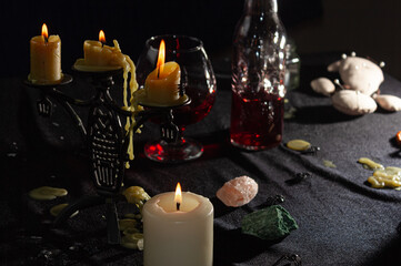 A bottle of red liquid like blood and a glass. Magical potion. The concept of wizards, witchcraft and magic. Halloween.