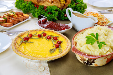 Christmas or Thanksgiving dishes pumpkin pie decorated with cranberries.