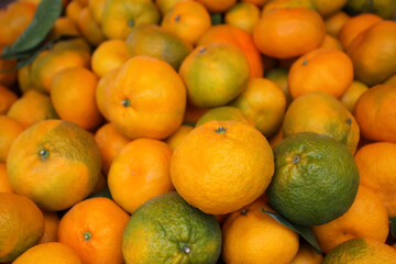 Background of ripe tangerines. Tangerines are sold at the market. Tangerines are new year's fruits, delicious and healthy citrus fruits.