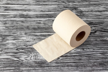 Eco-friendly bamboo toilet paper on a black wooden background.