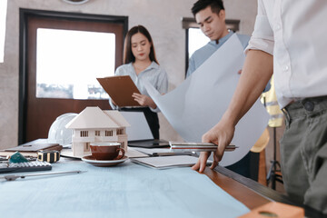 Fototapeta premium industry manager and engineer, businessman reading and checking blueprint, drawing in the room