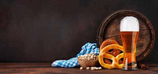 Lager beer with pretzels and old barrel