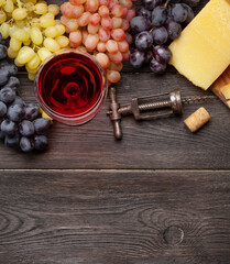 Various grapes, glass of wine and cheese