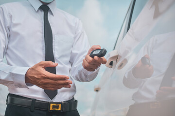 Fototapeta premium Businessman holding key car opening car door