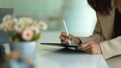Businesswoman hands using digital tablet on white worktable