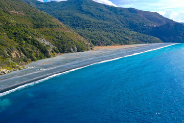 Aerial view of a long beach in Nonza, although its gray color is a bit off-putting. This color is...