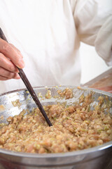 Chopsticks are placed in the meat to prepare dumplings
