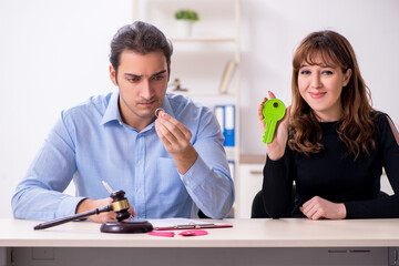 Young pair in courthouse in divorcing concept