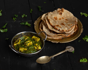 Indian Cuisine Palak Paneer Served With Tandoori Roti on Vintage Wooden Background