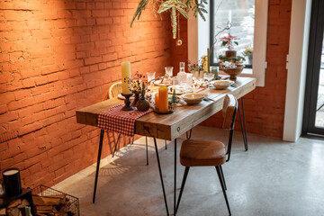 Stylish home interior with festively decorated dining table. The concept of interior design during the New Year holidays