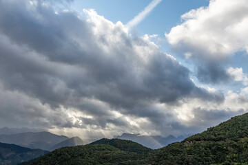 green mountains landscape with blue sky full of clouds, dramatic cloudy sky