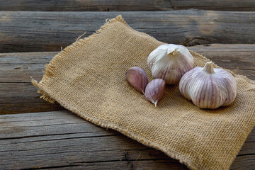 Garlic on sackcloth and an old blackboard. Close up.