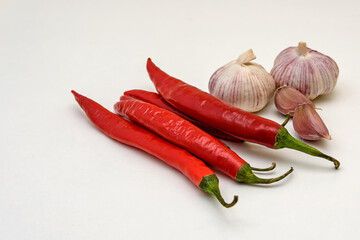 Hot red pepper and garlic on a white background. Close up.