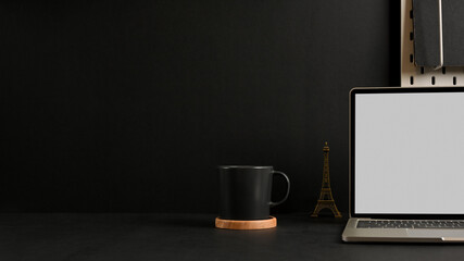 Modern workspace with open blank screen laptop and coffee cup 