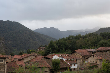 Fototapeta na wymiar landscape of a town in the mountains, aerial view of the rooftops and a bit of fog
