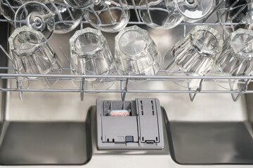 clean glasses and wine glasses in the dishwasher top view, close-up