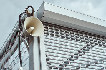 Speaker for announcing outdoor. Public megaphone on building construction