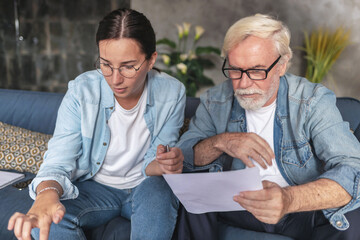 Retired adult man reading life insurance policy