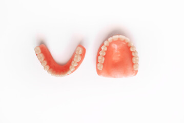 Dental prosthetics on a white background. Dentures. Prosthetic teeth. False teeth. Prosthetic dentistry. Set of dentures on a white background. Top view of complete denture on white background