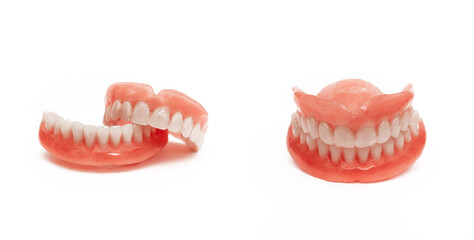 Full removable plastic denture of the jaws. Set of dentures on a white background. Two acrylic...
