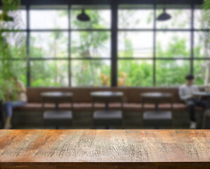 wood table top on blur cafe shop in distancing for present