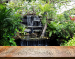 Fototapeta na wymiar wood table top on waterfal garden for display product