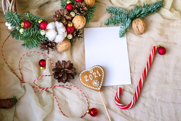 Cute Christmas flat lay with ginger bread man and bokeh lights on wood. Mockup gift card 2021