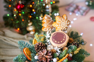 Cute Christmas flat lay with ginger bread man and bokeh lights on wood. Mockup gift card