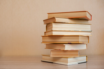 A stack of books stand on the table