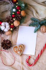 Cute Christmas flat lay with ginger bread man and bokeh lights on wood. Mockup gift card
