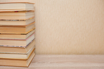 A stack of books stand on the table