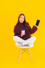 Portrait beautiful young asian woman use smart mobile phone on chair