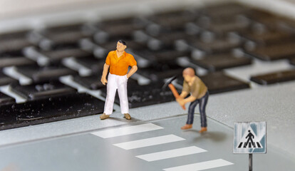 Road construction site with miniature workers