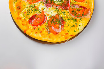 Pepperoni pizza on a white background. Traditional Italian pizza with tomatoes and meat isolated on white.