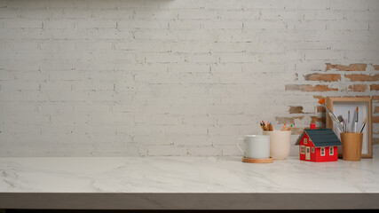 Workspace with stationery, cup, decorations and copy space on marble desk