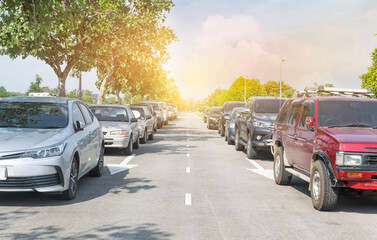 Cars parked in a row on street side under trees. business cars parking on road side, travel...