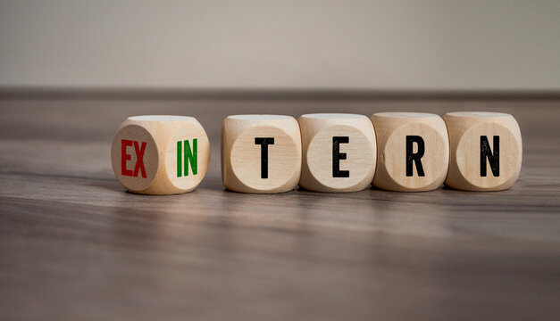 Cubes, dice or blocks showing the german words for external and internal - extern and intern on wooden background