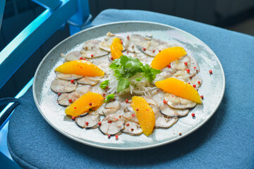 Balsamic salad with mixed seafood and fruit. Delicious orange and fish salad.